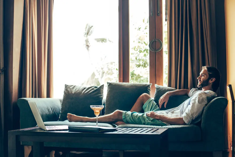 Man relaxing on a sofa in his living room.